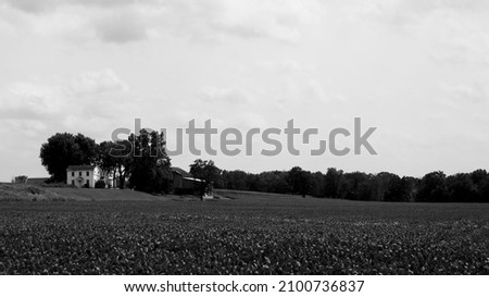 A greyscale shot of a farmhouse
