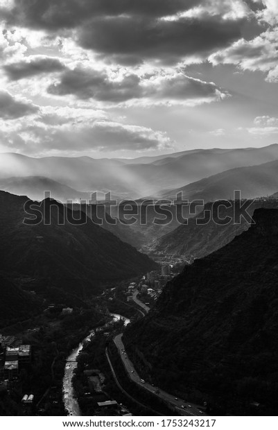 The\
greyscale shot of the roads through the\
mountains