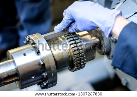 Grid coupling installation showing alignment, grease application, spacing, and torque applied to bolts. Application is a pump being coupled with an industrial motor with a metallic coupling