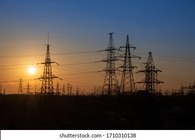 Grid High Voltage Power Lines. High Voltage Tower Sky Sunset Background