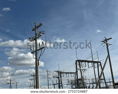 Grid infrastructure and transmission framework structures rising across open prairie sky in rural Alberta energy corridor.