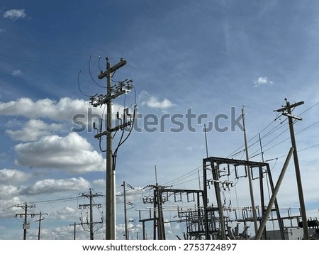 Grid infrastructure and transmission framework structures rising across open prairie sky in rural Alberta energy corridor.