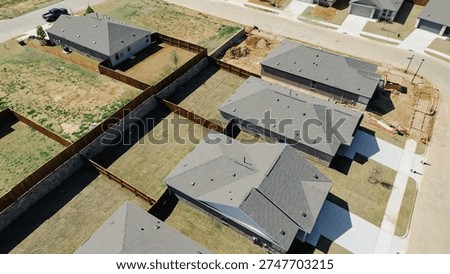 Grid patterned home rows at Highpointe Ranch, US 377, Blackjack Rd form clean subdivision with fenced yards, active construction on select lots. Dark roofs, fresh sod, disturbed soil, Aubrey, TX. USA