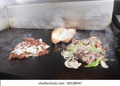 Griddle with Steak and Peperoni Submarine Sandwich and Bacon Mushrooms - Powered by Shutterstock