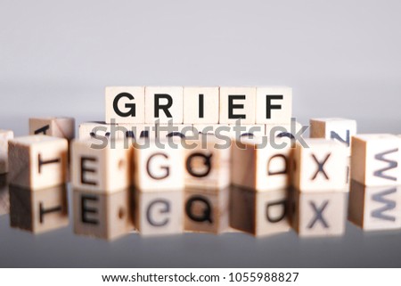 Grief word cube on reflection