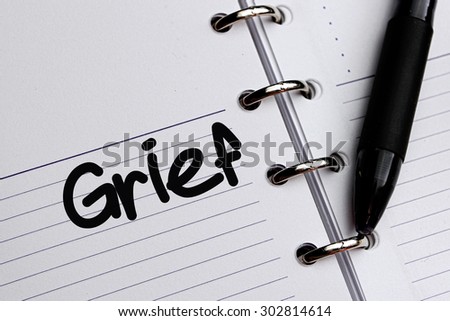 Grief word written on notebook