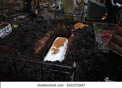 Grieving Relatives Bury A White Coffin In A Pit, Throwing The Coffin To The Ground