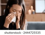 Grieving young Asian woman crying at funeral, closeup