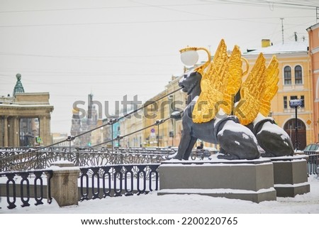 Griffins on Bank bridge on Griboedov canal embankment on a cold snowy winter day in Saint Petersburg, Russia