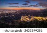 Griffith Observatory and city of Los Angeles skyline panorama at dusk. Aerial view.