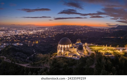 Griffith Observatory and city of Los Angeles skyline panorama at dusk. Aerial view.