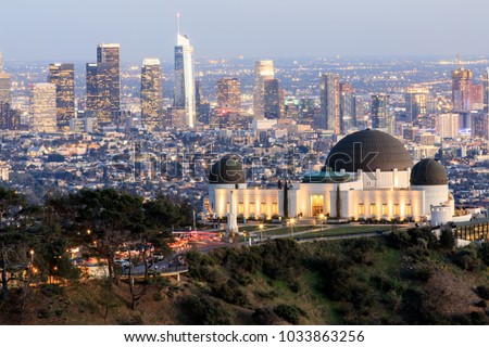 Griffith Observatory Park with Los Angeles Skyline at Dusk. Twilight views of the famous monument and downtown from Santa Monica Eastern Mountains. Los Angeles, California, USA.
