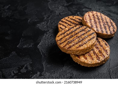 Griiled meat free patties, plant based meat steak cutlets. Black background. Top view. Copy space. - Powered by Shutterstock