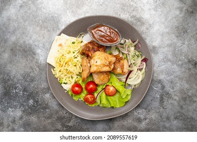 Griled Chiken Filet With Tomatoes And Green Letuce Salad, Cabbage Salad And Red Onion, Grilled Potatoes On The Plate.