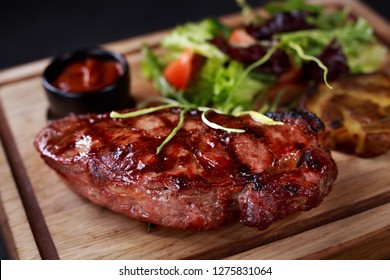 Grill And Barbeque, Meat Restaurant Menu, New York Steak, Striploin, Kansas, Strip Steak Served With Vegetable Salad And Potatoes On Board, Traditional American Cuisine