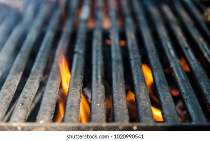 Grill Bbq Close Up And Bright Hot Flames, Outside Summer Cookout, Empty Barbecue Burning Wood With Smoke, Blurred Fire And Charcoal Briquettes