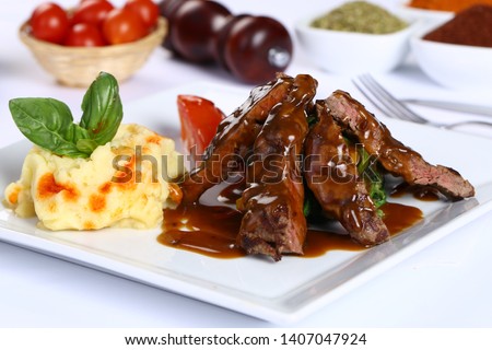 Grill beef tenderloin with barbecue sauce and mashed potatoes on white plate