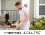 Grill chef cook. Guy with BBQ cooking tools. Barbecue and grill. Picnic and barbecue party. Chief cook with utensils for barbecue grill. Barbeque on holiday picnic. Man grilling a steak on BBQ.