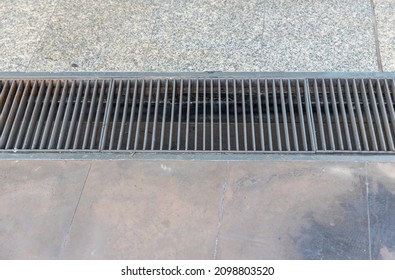 Grille drain sewer around the street walkway   Water recirculation system  Wastewater treatment  Grille the drainage system the pedestrian sidewalk 