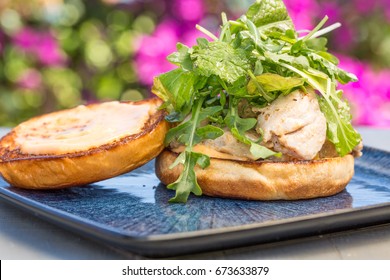 Grilled Ahi Tuna Steak Topped With Arugula Served On A Bun