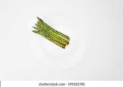 Grilled Asparagus On Glass Plate, On A White Background