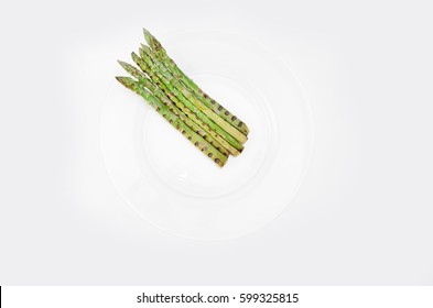 Grilled Asparagus On Glass Plate, On A White Background