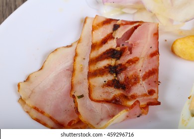 Grilled bacon with potato, onion and tomato
