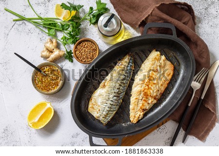 Grilled baked mackerel with ginger mustard honey sauce on a marble table top. Top view flat lay. 