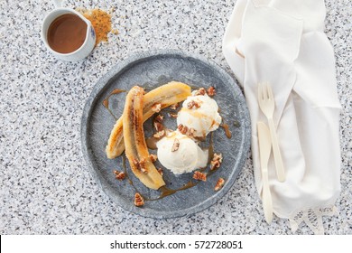 Grilled banana with vanilla ice cream and pecan nuts