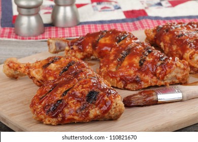 Grilled Bbq Chicken Quarters On A Cutting Board