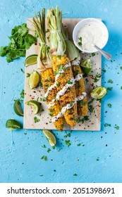 Grilled BBQ Corn Cob With Herbs, Lime And Garlic Sauce. Mexican Street Food Or Summer Garden Party Snack.