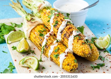 Grilled BBQ Corn Cob With Herbs, Lime And Garlic Sauce. Mexican Street Food Or Summer Garden Party Snack.