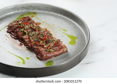 Grilled Beef Chuck Steak Closeup. Sliced Steak With Chili Pepper On Ceramic Plate.