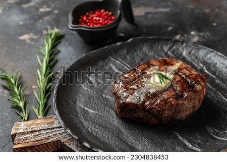 grilled beef medallions on a wooden board. Restaurant menu, dieting, cookbook recipe top view.