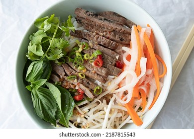 Grilled beef noodle bowl with fresh basil, pickled daikon and radish and bean sprouts. - Powered by Shutterstock