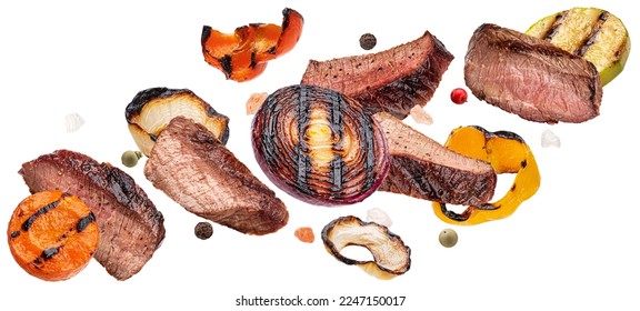 Grilled beef slices and chopped vegetables isolated on white background - Shutterstock ID 2247150017