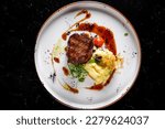 Grilled beef steak filet mignon with potato and sauce in plate
