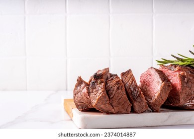 Grilled beef steak with herb and spices. Portion of fried meat cuts with rosemary, garlic, olive oil and ketchup sauce