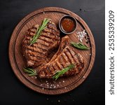 Grilled beef steak medium rare on a black stone table. Top view. 