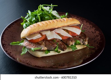 Grilled Beef Steak Medium Sliced Ciabatta Sandwich Salad Tomato Parmesan Cheese Rocket Green Rustic Plate 