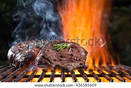 Grilled beef steak on the grill, close-up.