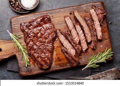 Grilled Beef Steak On Wooden Board. Top View Flat Lay