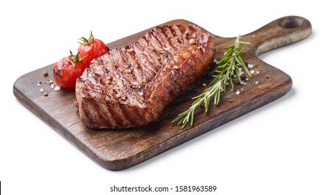 Grilled beef steak on wooden board with tomatoes and rosemary isolated on white background