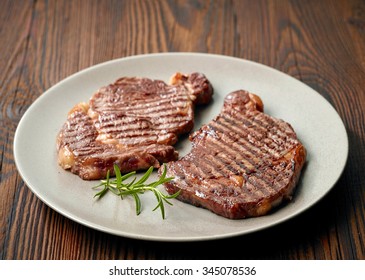 Grilled Beef Steak And Rosemary On A Plate