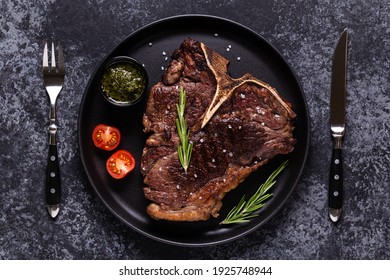 Grilled Beef Steak With Spices On A Black Plate, Top View.