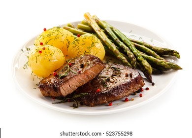 Grilled Beef Steaks And Asparagus On White Background