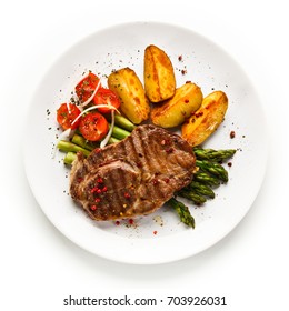 Grilled Beef Steaks,chips And Asparagus On White Background 