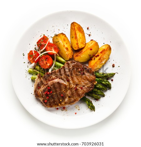 Grilled beef steaks,chips and asparagus on white background 