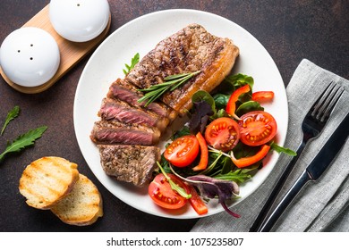 Grilled Beef Striploin Steak With Fresh Salad Top View.