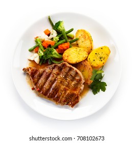 Grilled beefsteak with broccoli and carrot on white background 
